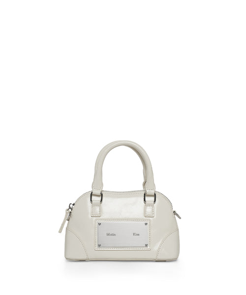 MATIN KIM MATIN KIM CURVE ZIP MINI BAG in Light Grey